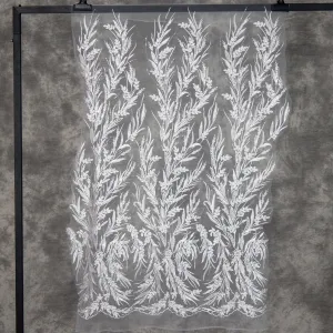 shimmering sequined leaf plant off white lace fabric