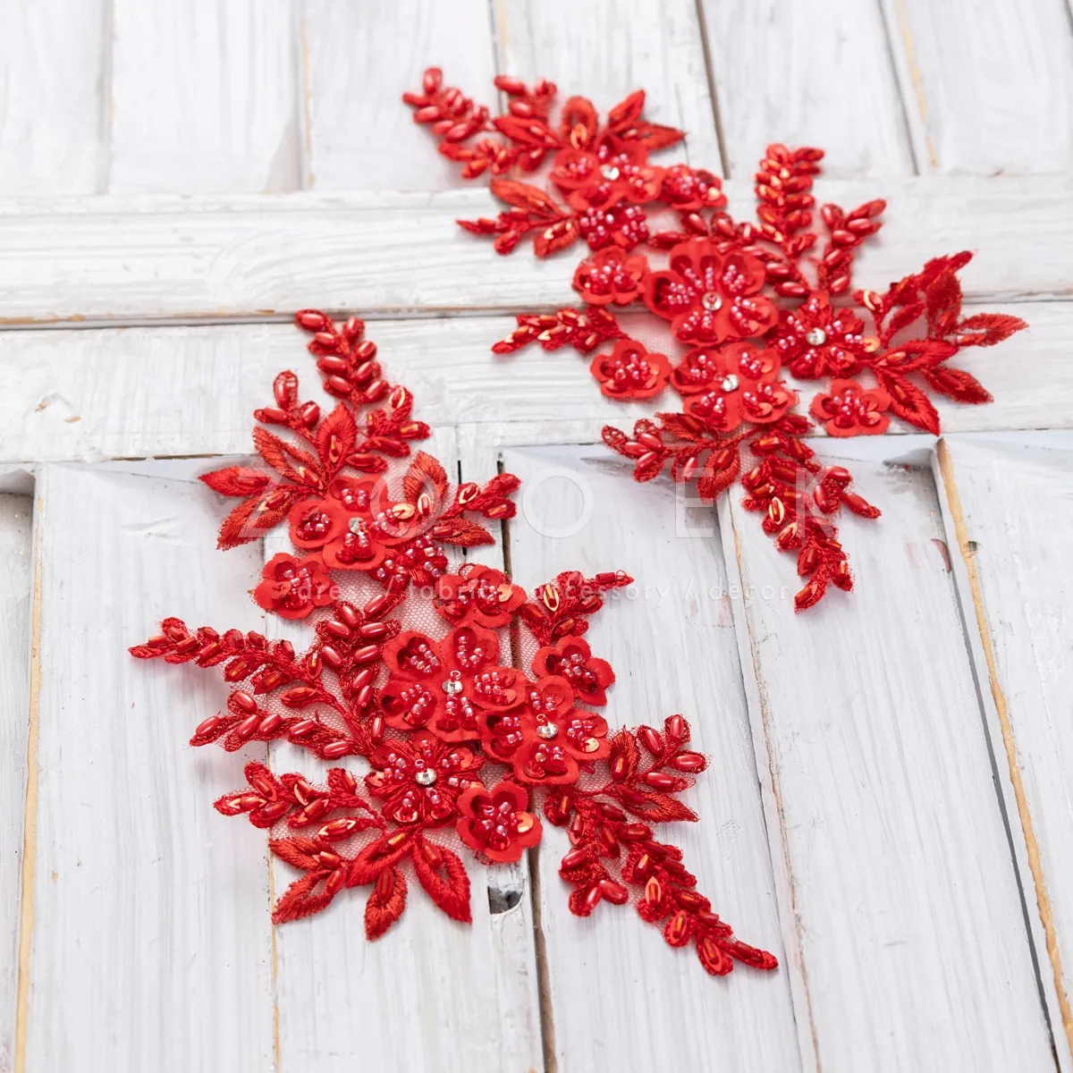 pair of bright red shiny beaded floral lace appliques