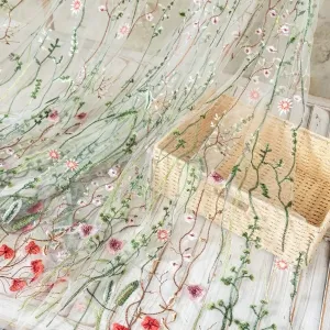 nude mesh adorned with vibrant green aquatic plant embroidery