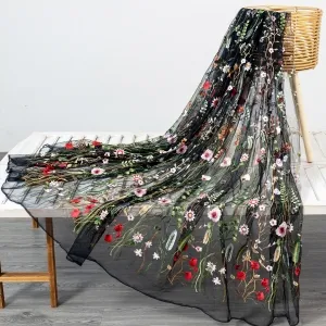 multi color floral plant embroidered on black mesh fabric